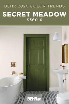 a bathroom with a green door next to a white bath tub and sink in it