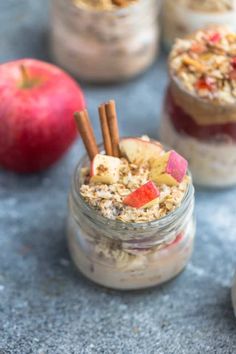 three jars filled with oatmeal, apples and cinnamon sticks on top of a table