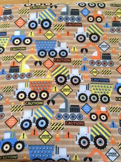 a close up of a fabric with tractors on it