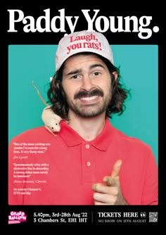 a man with long hair wearing a red shirt and white hat is giving the peace sign