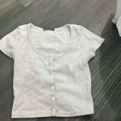 My Item Is A Brandy Melville, Gray And White Shirt With White Buttons Going Upwards And Round Neck, Good Condition And Real Original Tag. Basic Striped Short Sleeve Tops, Cute Striped Cotton Tops, Cute Striped Short Sleeve Tops, Brandy Melville Shirts, Brandy Melville T Shirts, Form Fitting Tops, Coquette Cottagecore, Blue Crop Tops, Striped Short