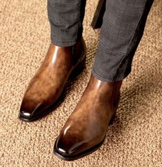 a close up of a person wearing brown shoes