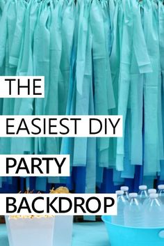 the easyest diy party backdrop with blue and white paper bags in front of it