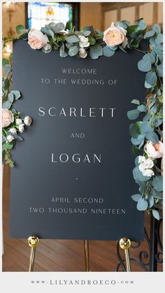 a sign with flowers and greenery on it for a wedding ceremony at the cathedral