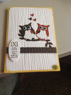 a card with two owls sitting on a tree branch and the words love is in the middle