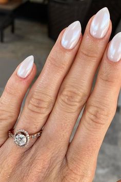 Experience the allure of a mountain peak elegance with these Iridescent Pearl nails. Click through to discover more captivating nail ideas for a polished and graceful look. ✨ // Photo Credit: Instagram @honeydipped_byemma Bridal Nails Wedding Dip Powder, Honey Moon Nails, Matron Of Honor Nails, Beach Engagement Nails, Engagement Pic Nails, Fun Bachelorette Nails, Christmas Engagement Nails, Bridal Nails Almond, Wedding Nails Pearl