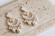 A beautiful pair of bridal earrings made with high quality freshwater pearls in an array of shapes and sizes for a stunning natural look.  The earrings measure approximately 2.5" in length and 1" in width. Please message if you require alternative sizes. The earrings are available in gold, rose gold, or silver plate (all hooks are 14k gold filled, 14k rose gold filled or sterling silver to be safer for your ears). Alternatively you can opt for a more luxurious finish with all metal parts in 14k Dangle Pearl Drop Earrings In Mother Of Pearl, Dangle Mother Of Pearl Drop Earrings, Pearl White Drop Earrings Made Of Mother Of Pearl, Pearl Drop Earrings In Mother Of Pearl, Pearl White Drop Earrings In Mother Of Pearl, Pearl Charm Dangle Bridal Earrings, Pearl Charm Dangle Chandelier Earrings, Dangle Chandelier Earrings With Pearl Charm, Pearl Dangle Chandelier Earrings With Pearl Charm