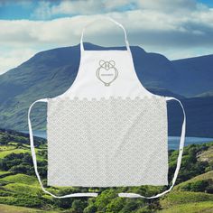 a white apron with an embroidered heart on the front, and two hearts in the middle