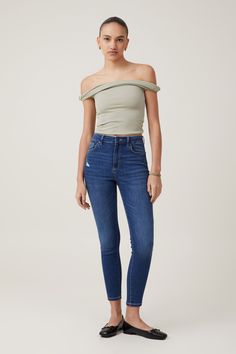 high rise skinny jean Distressed High Rise Jeggings, Chic High Rise Dark Wash Jeggings, Chic High-rise Dark Wash Jeggings, Fitted Jeggings With Frayed Hem, Casual High Rise Jeggings With Frayed Hem, Trendy Ripped High Rise Tops, High Rise Denim Blue Jeggings, Casual High Rise Distressed Jeggings, High Waist Denim Tops With Frayed Hem