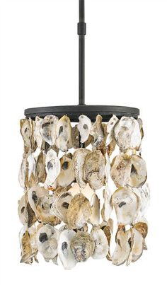 a chandelier made out of oysters hanging from a black ceiling fixture with white background