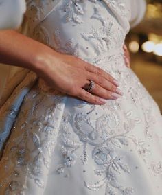 a woman in a wedding dress with her hand on the waist