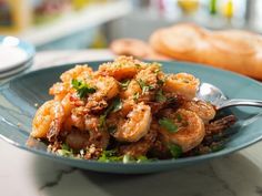 a blue plate topped with shrimp and bread