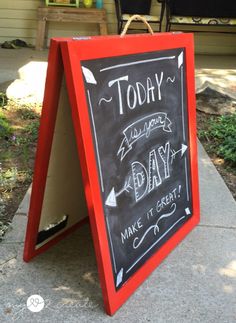 a chalkboard sign that says today is another day make it great on the sidewalk