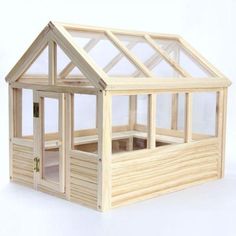 a wooden dollhouse with windows and doors on the outside, in front of a white background