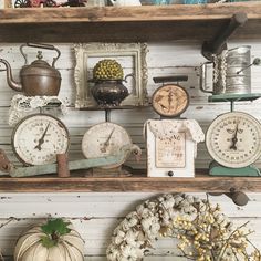 an assortment of clocks and other items on shelves