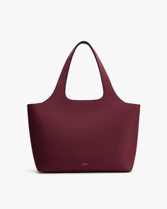 A large tote bag with a wide opening and two handles. Everyday Structured Shoulder Bag With Smooth Grain, Classic Structured Everyday Bag, Structured Soft Leather Bag For Everyday, Versatile Everyday Structured Bags, Versatile Structured Everyday Bags, Modern Laptop Bag With Removable Pouch For Shopping, Versatile Structured Bag For Everyday Use, Structured Bags For Everyday Use, Versatile Tote Satchel With Smooth Grain