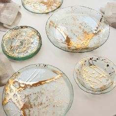 dirty glass plates sitting on top of a white table