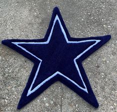 a blue and white star shaped rug on the ground