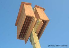 a close up of a wooden structure against a blue sky