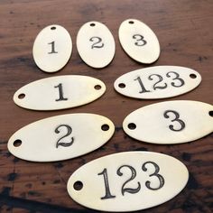 six numbered tags with numbers on them sitting on a table