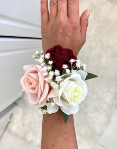 a woman's arm with flowers on it and her hand holding the wristband