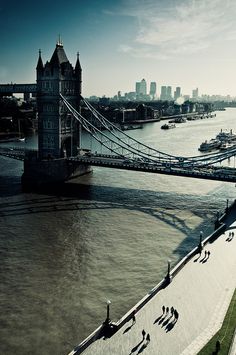 an aerial view of the river thames and tower bridge in london, england with people walking on it