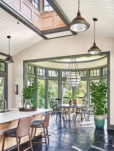 an open kitchen and dining room with large windows