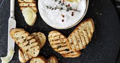 a black plate topped with crackers and cheese