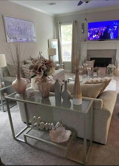 a living room filled with furniture and a flat screen tv mounted to the wall above it