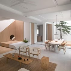 a living room filled with furniture and a tree in the middle of it's center