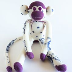 a sock monkey sitting on top of a white table