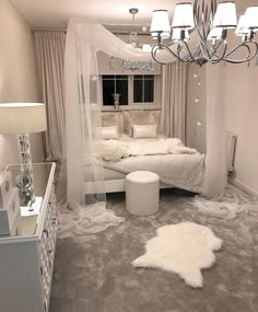 an instagram photo of a white bedroom with chandelier