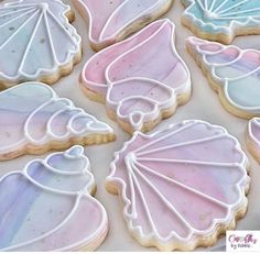 decorated cookies in pastel colors with seashells on them