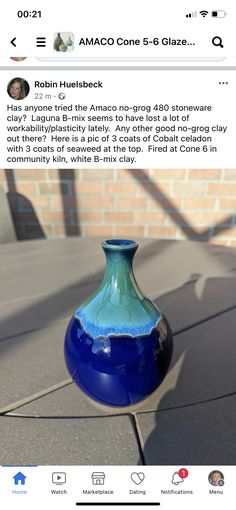 a blue vase sitting on top of a table