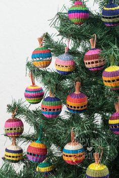 a christmas tree with colorful ornaments hanging from it's branches