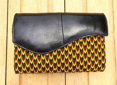 Afrique Chic genuine leather handmade clutches, blend traditional Ankara fabric designs with modern style, meticulously crafted by artisans for quality and unique flair.  Eye catching and vibrant, they are a statement of West African heritage and contemporary fashion. Multicolor Leather Rectangular Clutch, Multicolor Rectangular Leather Clutch, Handmade Leather Coin Clutch, Handmade Leather Coin Purse Clutch, Handmade Leather Clutch Coin Purse, Traditional Black Pouch Clutch, Multicolor Leather Pouch Wallet, Traditional Leather Wallets For Daily Use, Traditional Clutch With Removable Pouch For Everyday