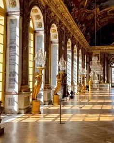 an ornate hallway with chandeliers and marble floors in a palace like setting,