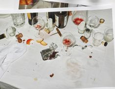 the table is covered with wine glasses and other items that have been left on it