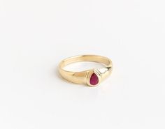 "Beautiful and unique solid gold ring signet ring set with pear-shaped ruby, alternative engagement or wedding ring. This wide 14K yellow gold ring is set with a pear-shaped Deep dark pink Ruby. The ring's wide design and the color of the Ruby give this ring a certain air of majestic and quiet confidence. This ring is comfortable and noticeable and will be great for everyday use, as for a special occasion. It can also be a modern engagement ring. This ring will be a perfect gift for a strong and Yellow Gold 14k Emerald Ring For Proposal, Yellow Gold Solitaire Ring For Proposal, Classic Teardrop Gemstone Rings, Fine Jewelry Yellow Gold Proposal Rings, Classic Teardrop Promise Ring, 14k Gold Solitaire Signet Ring, Classic Solitaire Teardrop Ring, 14k Gold Dome Ring With Bezel Setting For Promise, Yellow Gold Ring Jewelry For Proposal