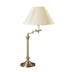 an antique brass lamp with a white shade on the base and a light bulb attached to it