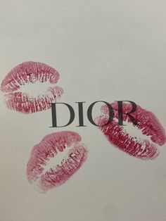 three pink lipstick imprints on top of a white paper with the word dior