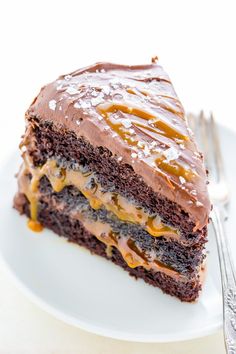 a piece of chocolate cake with caramel drizzle on top and frosting