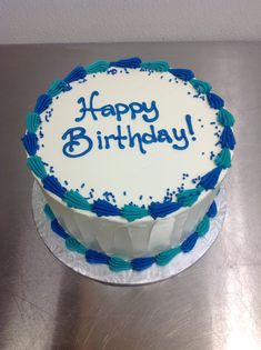 a birthday cake with the words happy birthday written in blue frosting on top of it