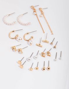 Mix and match your ear stack with our collection of versatile earring packs! From studs to huggie hoops, pick out a pack that best suits your personal style. This Gold Pearl Mixed Stud & Hoop Earrings 12-Pack includes twelve sets of earrings embellished with a mix of pearls for an elegant finish. | Lovisa Gold Pearl Mixed Stud & Hoop Earring 12-Pack, Clear Lovisa Earrings, Lovisa Jewellery, Earring Trends, Ear Stack, Birthday Wishlist, Favorite Rings, Gold Pearl, Cool Suits, Ring Necklace