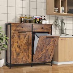 a wooden cabinet with two doors open in a kitchen next to a potted plant