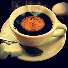 an old record in a coffee cup on a saucer