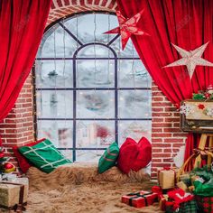 a window with red curtains and presents in front of it