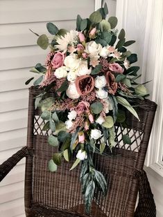 a bouquet of flowers sitting on top of a wicker chair