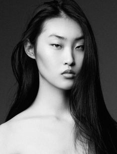 a black and white photo of a woman with long hair