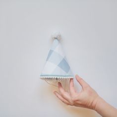 Your little one will be cute-as-can-be in our classic, keepsake party hat! With our unique design and quality materials, our party hats are unlike any other. They're constructed to be sturdy yet lightweight with heirloom-quality to be enjoyed year after year. We also fine-tuned our hats to be perfectly sized for children of all ages--not too big, not too small, they're truly just right. Each hat is hand-crafted by our team, lined inside, and finished with white mini pom pom trim, a coordinating Playful Blue Hat For First Birthday, Playful Blue Hats For Gifts, Playful Blue Hat For Gift, Playful Blue Hat As A Gift, Playful Blue Hat As Gift, Playful Mini Hats For Birthday, Playful Adjustable Mini Hats For Birthday, Playful Curved Brim Hat For Birthday, Playful Curved Brim Hat For Birthdays